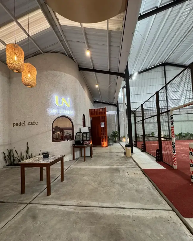 Café tables beside the court