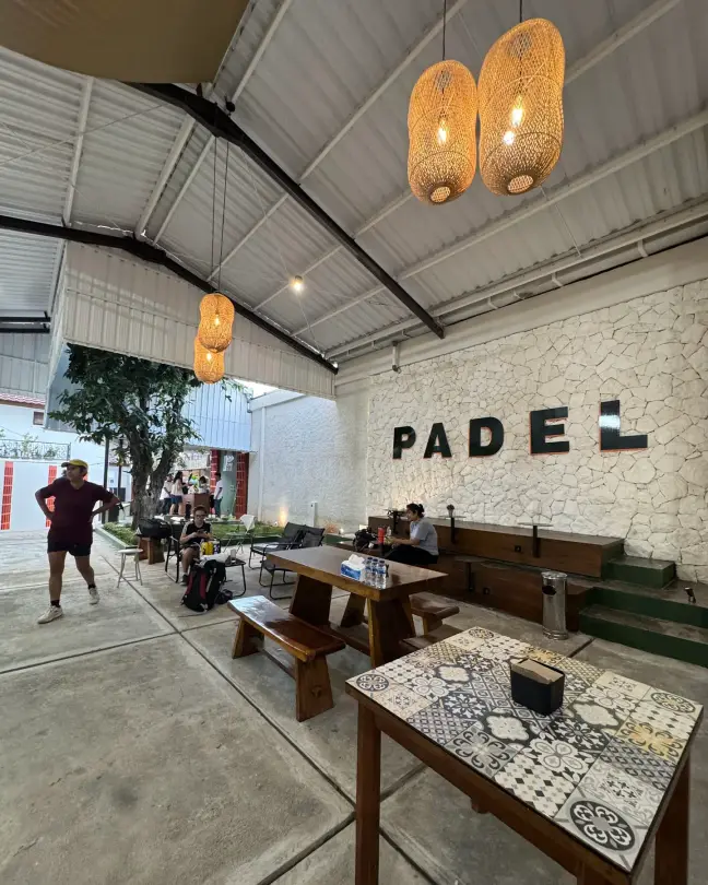 Tiled tables in the chill area under rattan lamps