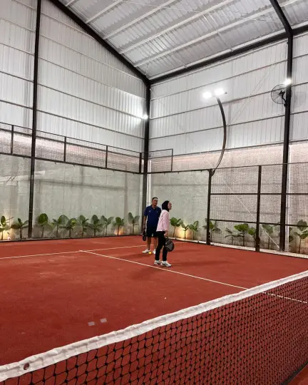 Players on the court under the white roof