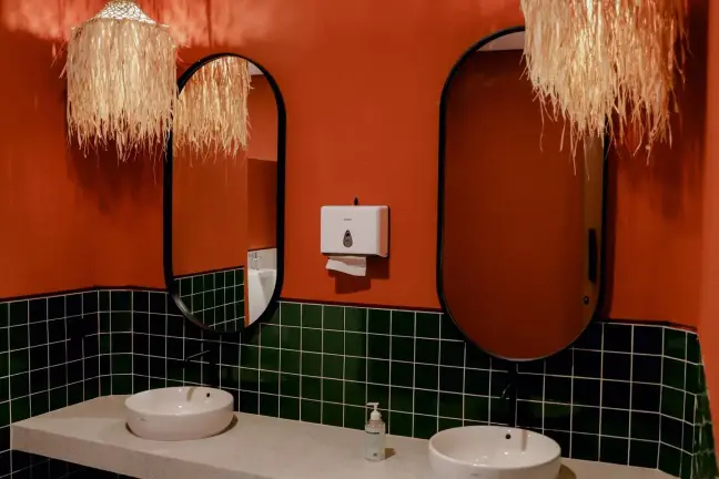 Terracotta and green-tiled restroom